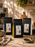 Elite Roasters light, medium, and dark roast coffee bags in a warm home coffee bar
