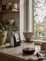 Elite Roasters light roast coffee beside a bright pour-over coffee setup 