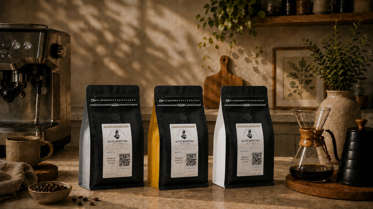 Current Elite Roasters black-front coffee bags with white, gold, and gray roast gussets in a kitchen